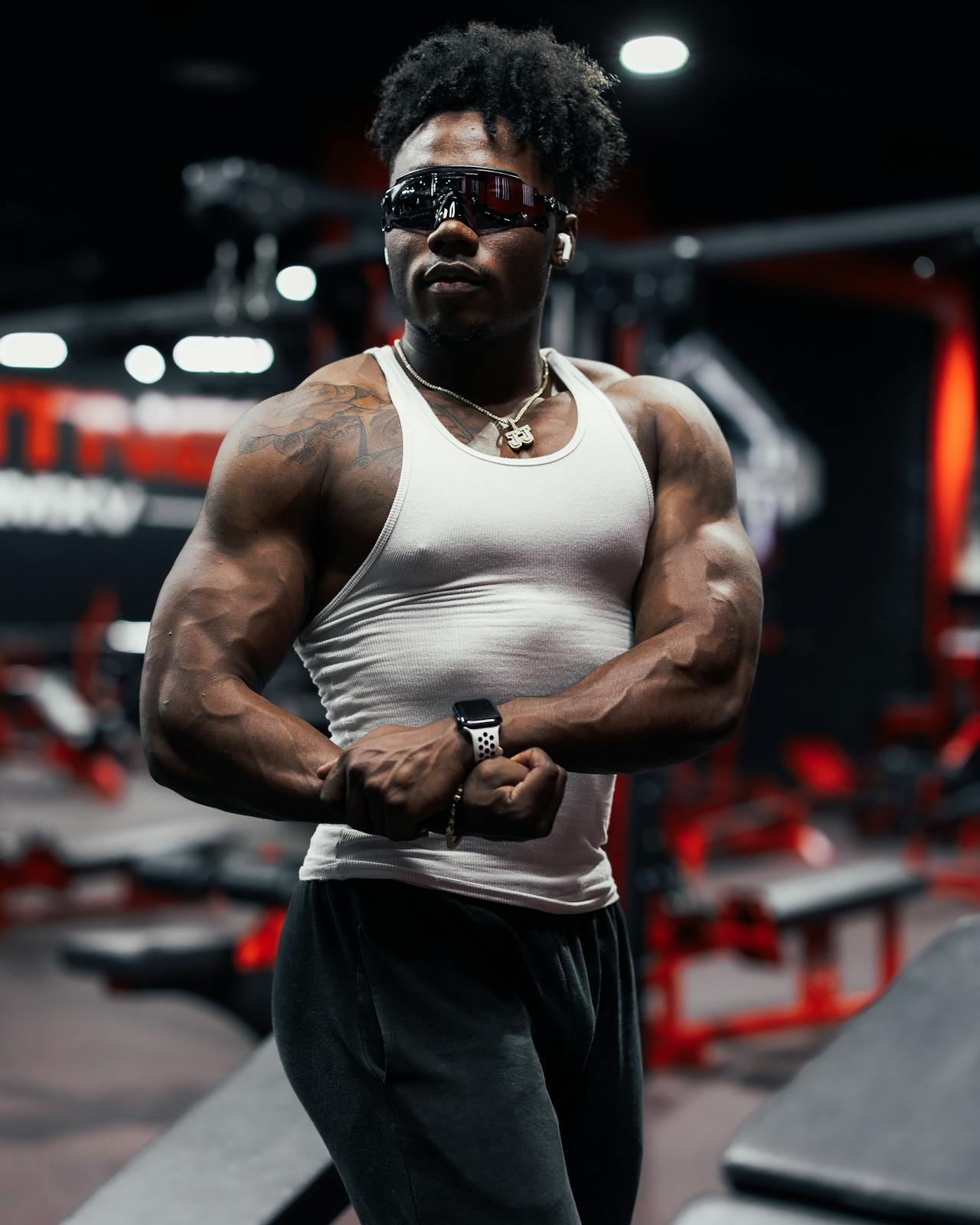 Bodybuilder met visor en oorbel in moderne gym